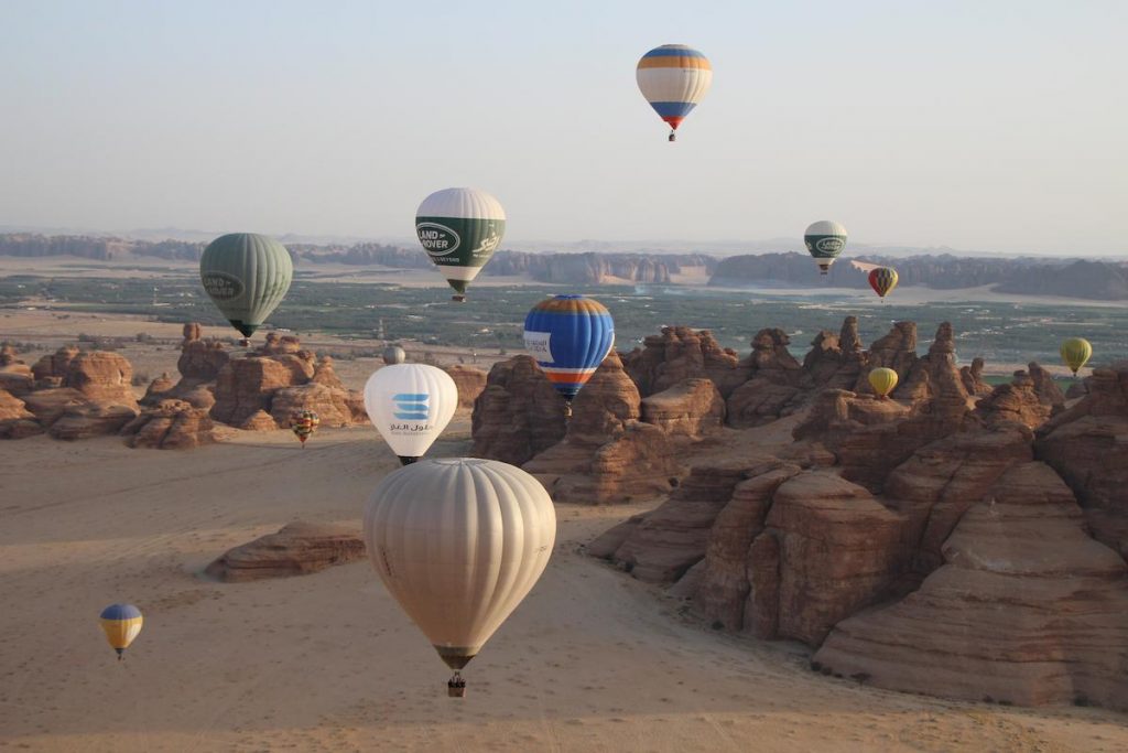 Hot air balloons over Hegra rocks